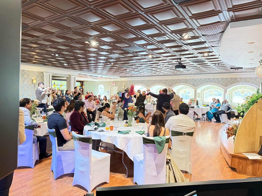 Guests gathered around tables during a private family celebration with music and dancing